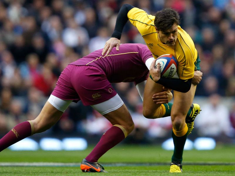 Adam Ashley-Cooper is tackled by Flood