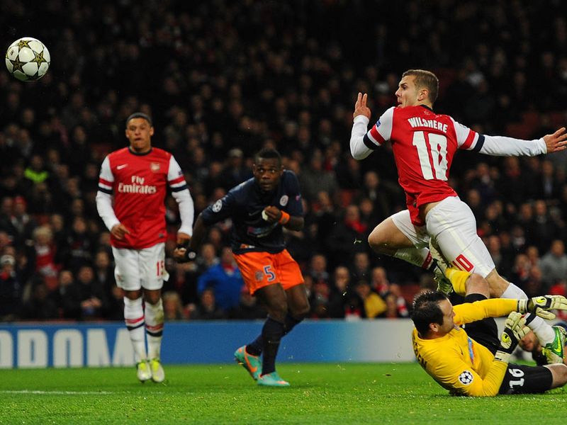 ..and Jack Wilshere nips in to delicately chip the ball over the outcoming keeper.