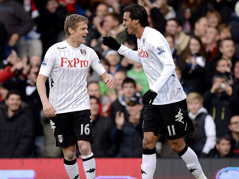 Early opener: Bryan Ruiz and Damien Duff celebrate Tim Howard's own goal which saw Fulham take the lead against Everton...