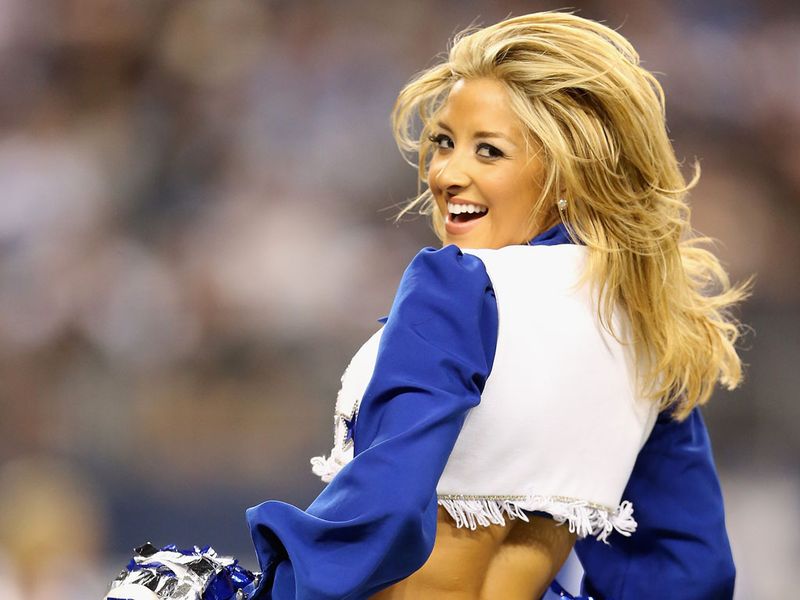 A Dallas Cowboys cheerleader attempts to cheer up the fans during their 38-31 defeat to Washington