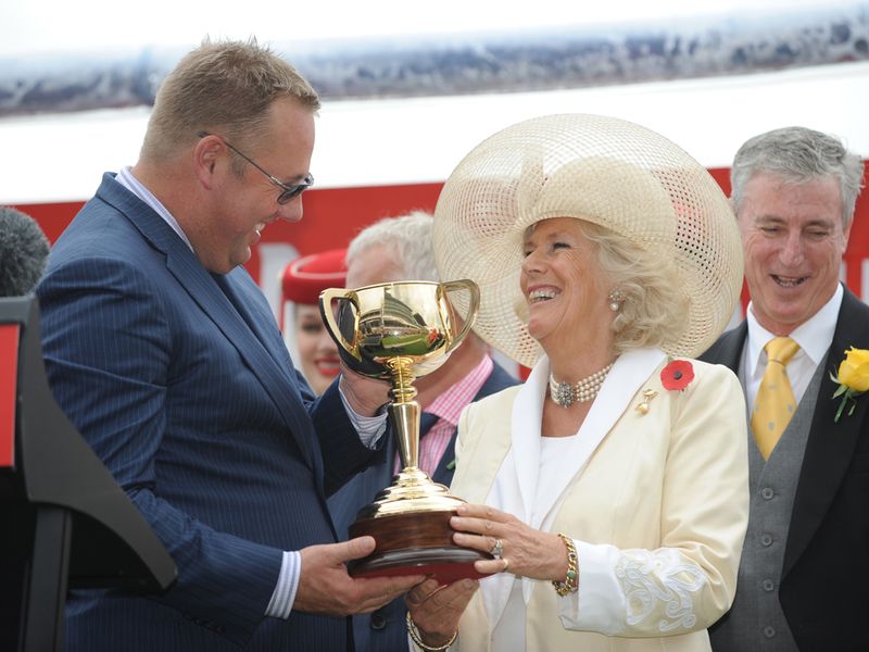 ...and winning owner Nick Mills receives the trophy from the Duchess Of Cornwall