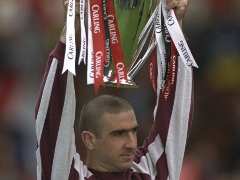 Cantona with the Premier League Trophy, his last piece of silverware for United in 1997.