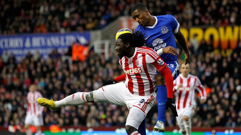 Everton defender Sylvain Distin does battle with Stoke's Kenwyne Jones