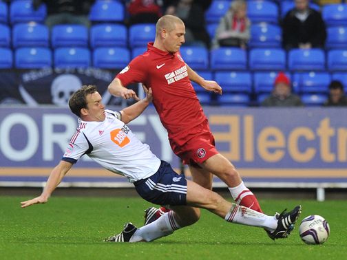Kevin Davies slides in on Michael Morrison