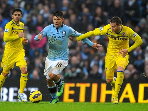 Sergio Aguero and Chris Gunter battle for the ball