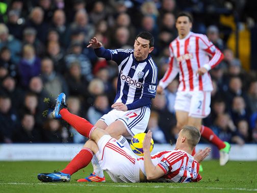 Ryan Shawcross slides in on Graham Dorrans