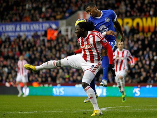 Sylvain Distin does battle with Stoke's Kenwyne Jones