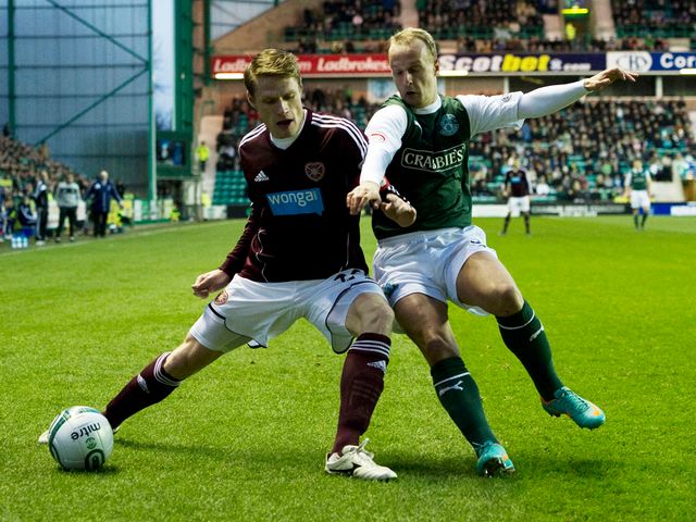 Marius Zaliukas holds off Leigh Griffiths.