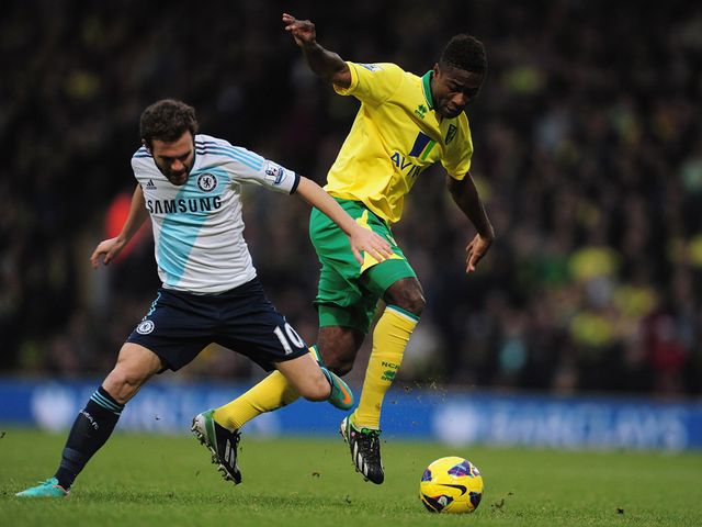 Juan Mata and Alex Tettey battle for the ball