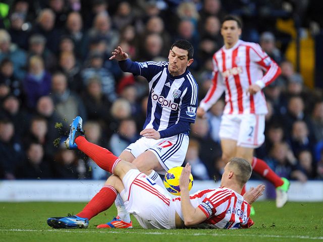 Ryan Shawcross slides in on Graham Dorrans