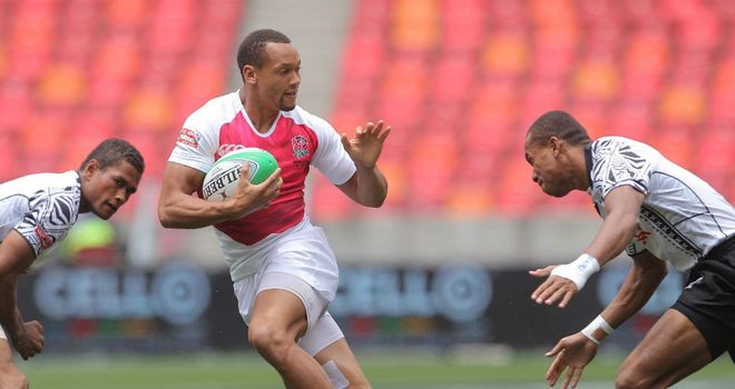 England star Dan Norton tries to avoid the Fiji defence at the Nelson Mandela Bay Sevens (Photo: IRB/Carl Fourie)