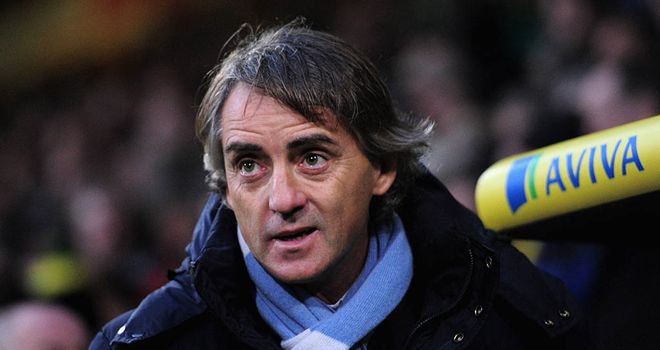 Roberto Mancini: Thinks Man City remain on the title trail