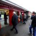 Racegoers go through the turnstiles for the final time