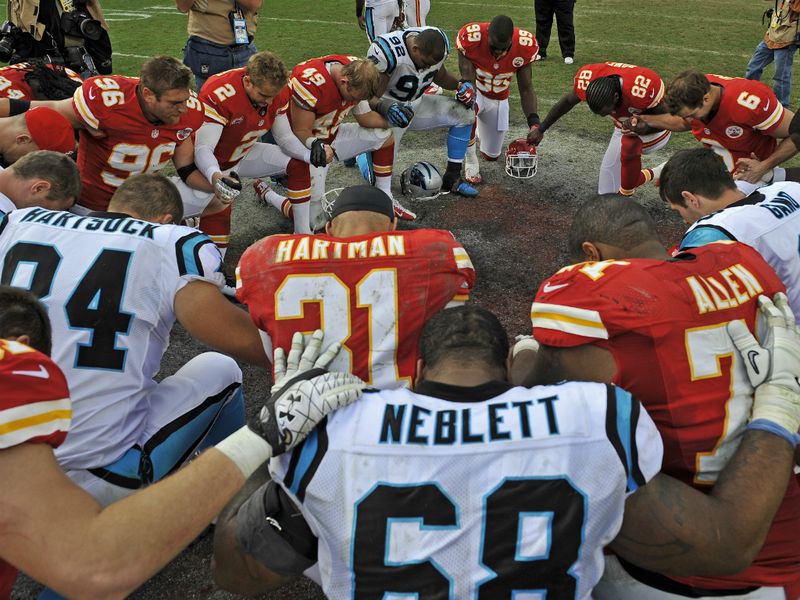 The Kansas City and Carolina players came together for a post-game prayer. Belcher is suspected of killing his girlfriend before turning the gun on himself