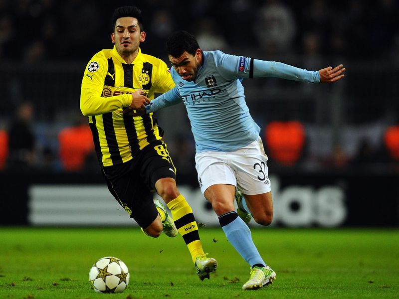 Ilkay Guendogan and Carlos Tevez battle for the ball