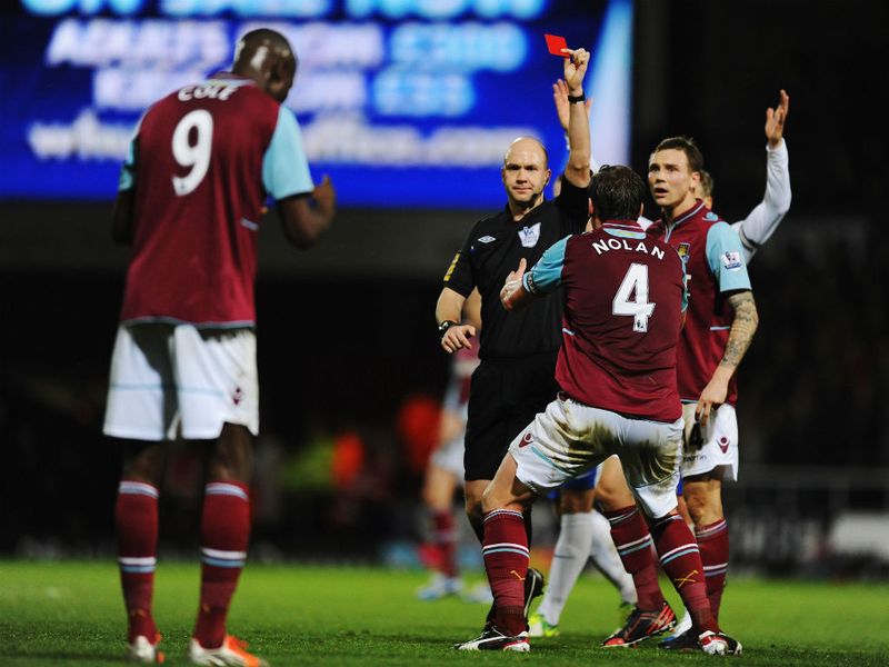 Carlton Cole receives a baffling red card, as his challenge for an aerial ball is considered dangerous play.