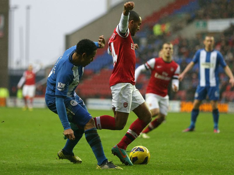 Walcott skips away from Jean Beausejour before being clipped by the Chilean and awarded a penalty.