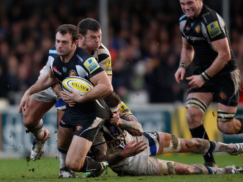 Hard game: Luke Arscott is stopped in his tracks during the 12-12 derby draw