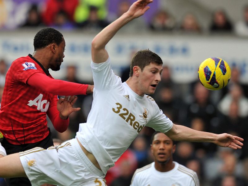 In the first game of the day, Patrice Evra heads home for Manchester United at Swansea