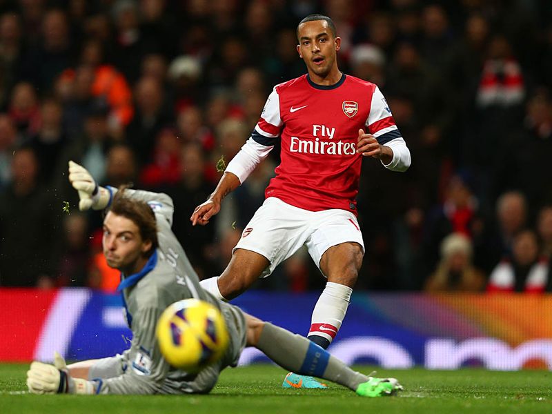 In the late kick-off, Theo Walcott breaks the offside trap and neatly curls into the far corner to give Arsenal the lead against Newcastle.
