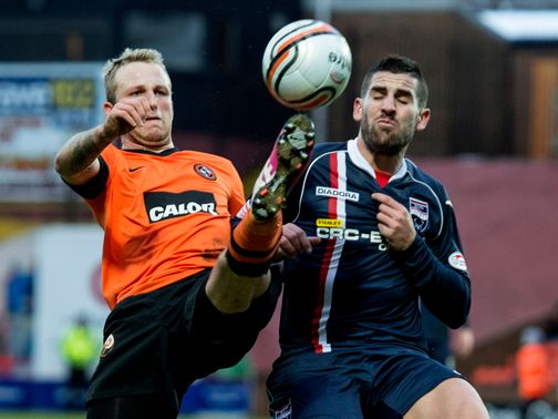 Johnny Russell and Evangelos Ikowomou battle for the ball