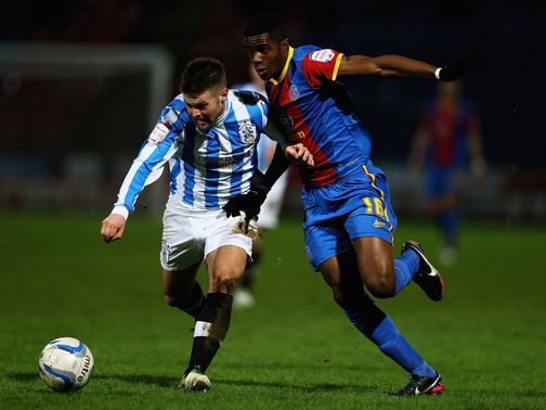 Oliver Norwood and Wilfried Zaha battle for the ball