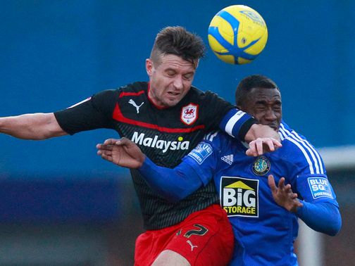 Stephen McPhail and Amari Morgan Smith go for a header