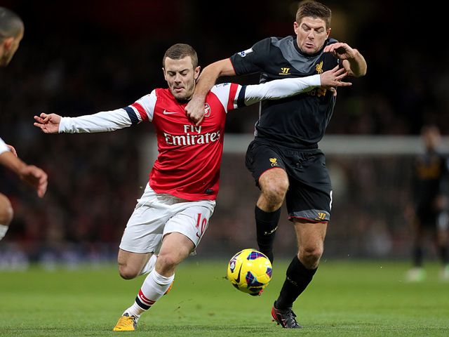 Jack Wilshere and Steven Gerrard battle for possession