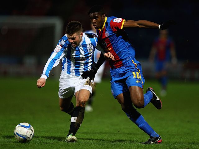 Oliver Norwood and Wilfried Zaha battle for the ball