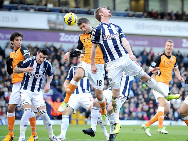 Aaron Hughes and Chris Brunt compete for the ball