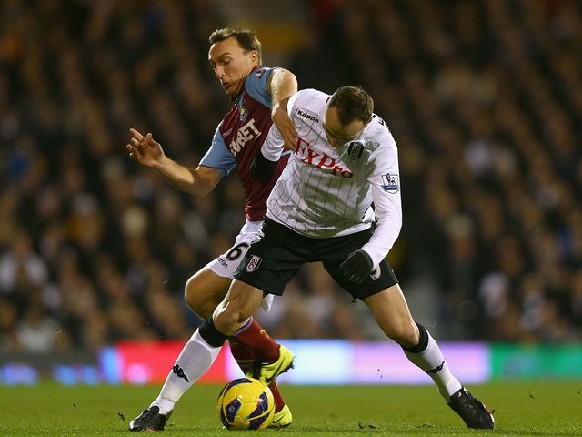 Mark Noble and Dimitar Berbatov tussle at Craven Cottage