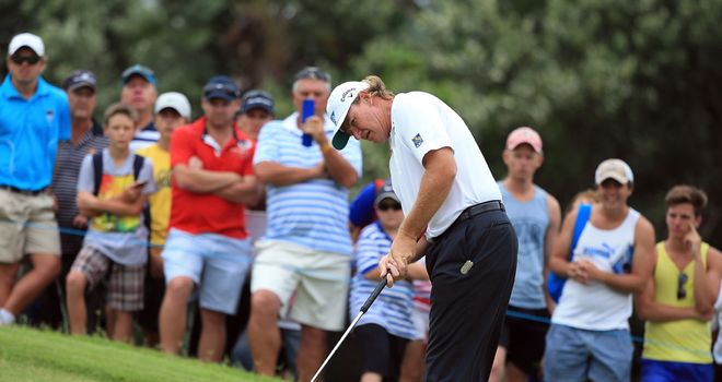 Ernie Els putting during his opening four-under 68
