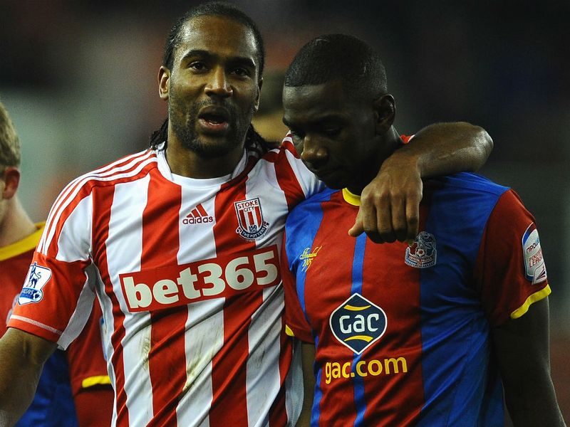 Scorer of Stoke's fourth goal Cameron Jerome consoles Yannick Bolasie