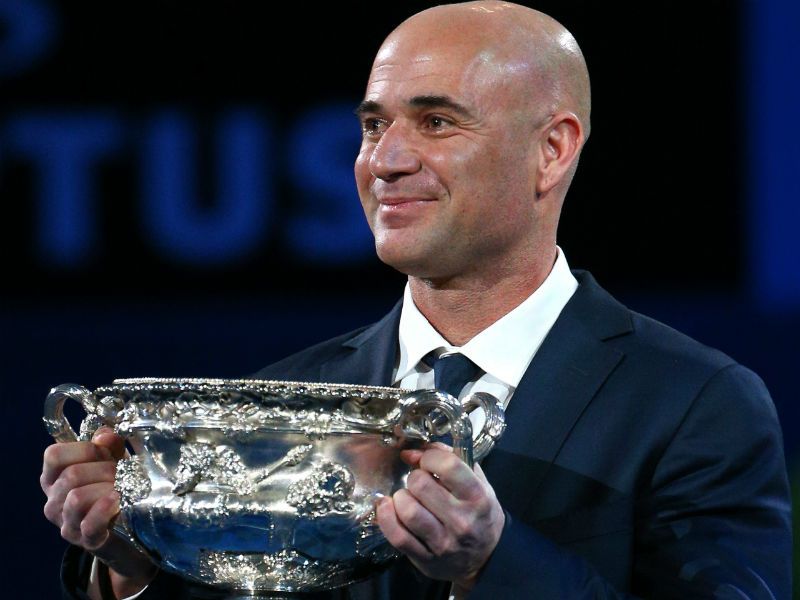 Familiar face: Four-time Australian Open men's singles champion Andre Agassi carries the Norman Brookes Challenge Cup ahead of play