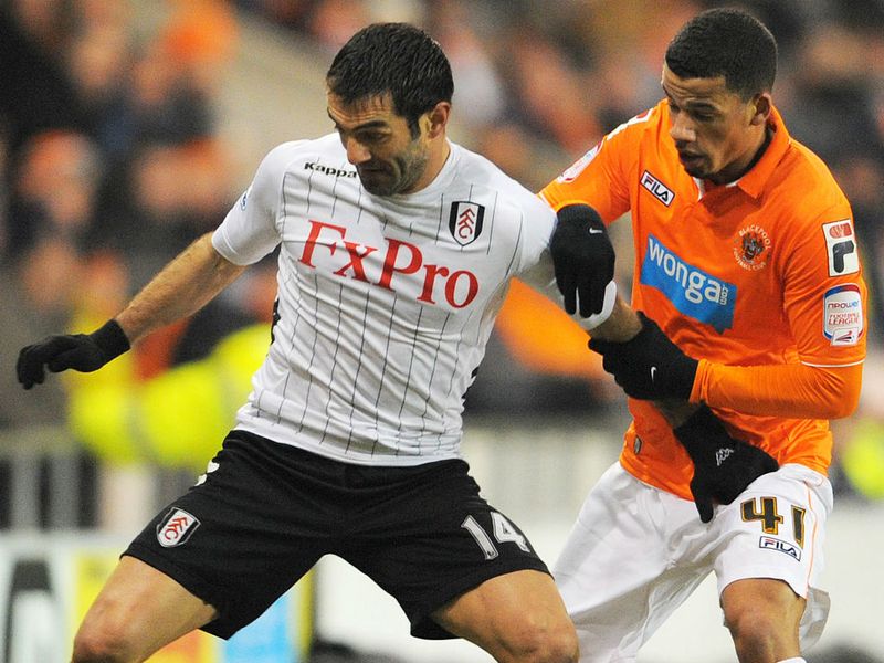 Fulham's Giorgos Karagounis fends away the attentions of striker Nathan Ecclestone