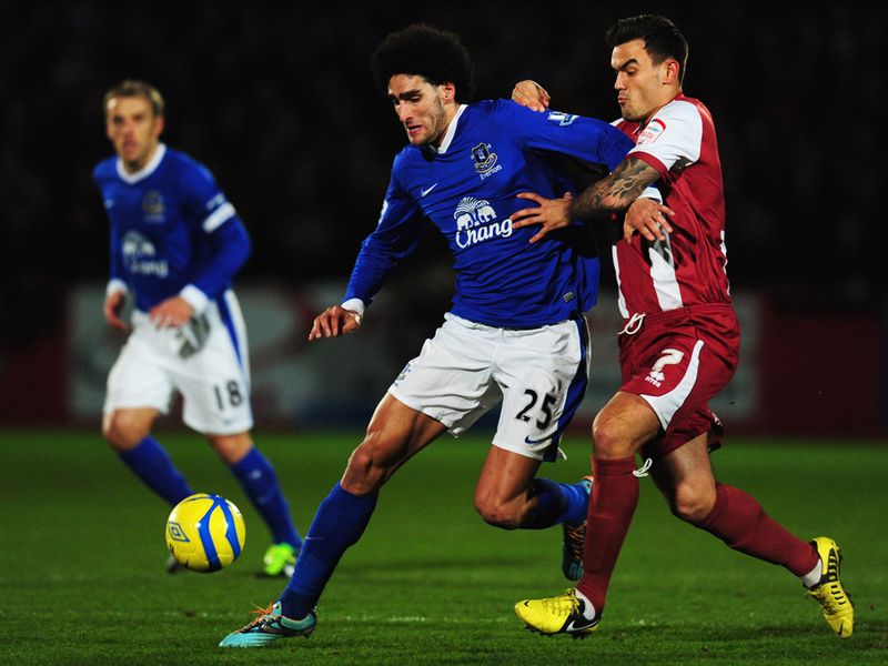 Marouane Fellaini holds off Marlon Pack early in the game