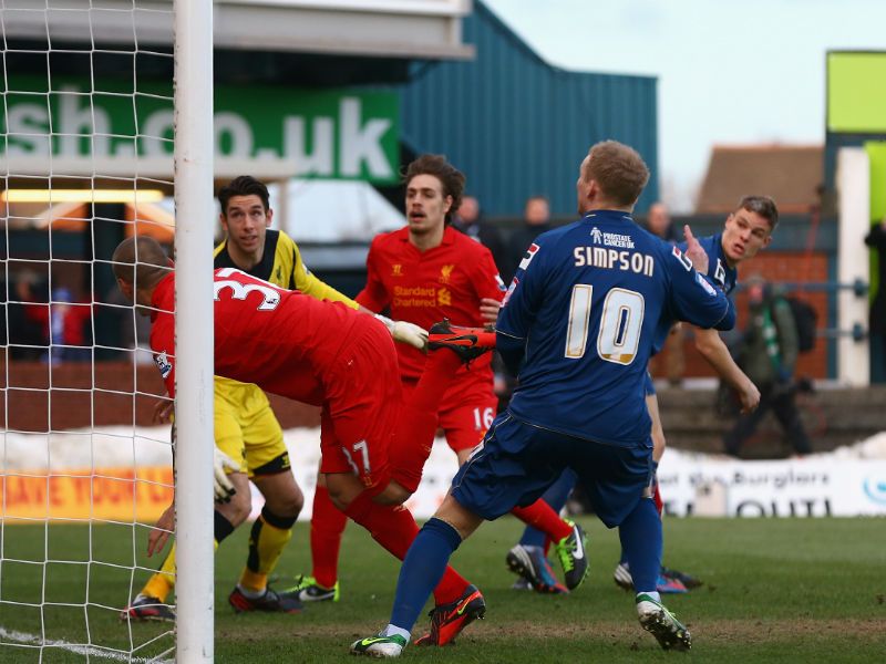 Early goal: Martin Skrtel is unable to clear Matt Smith's opener for Oldham in their shock 3-2 win over Liverpool...