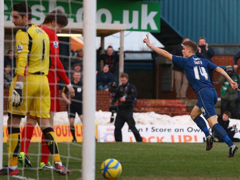 ...with the Oldham player celebrating his effort at Boundary Park