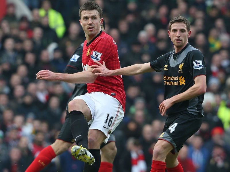 Giving their all: Michael Carrick pictured in action with Joe Allen