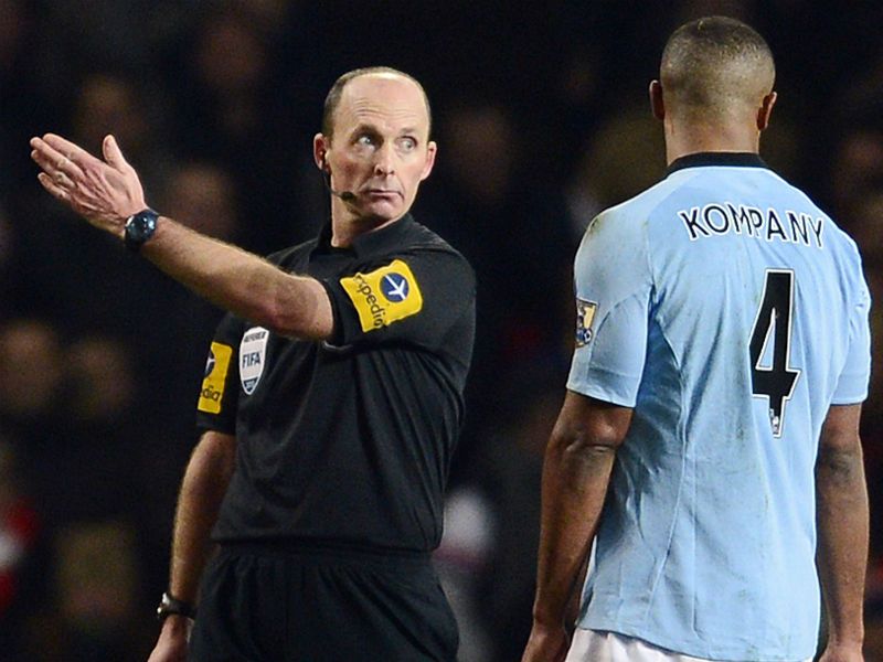 Long walk: Vincent Kompany is sent on his way by Mike Dean