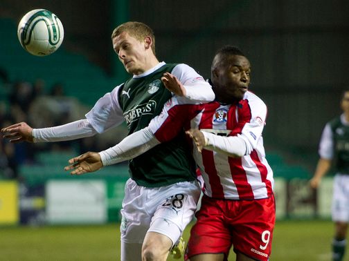 Scott Robertson tussles for possession with William Gros