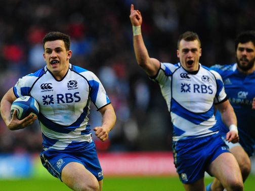 Scotland full-back Stuart Hogg celebrates as Matthew Scott runs in a try