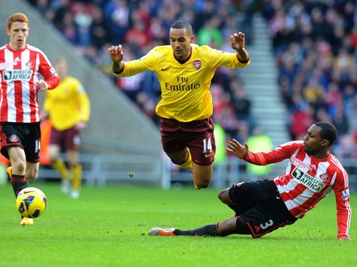 Theo Walcott is brought down by Sunderland's Danny Rose