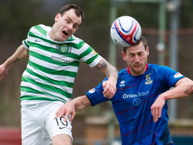 Anthony Stokes and Gary Warren battle for the ball