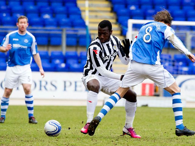 Esmael Goncalves skips past the challenge from Murray Davidson