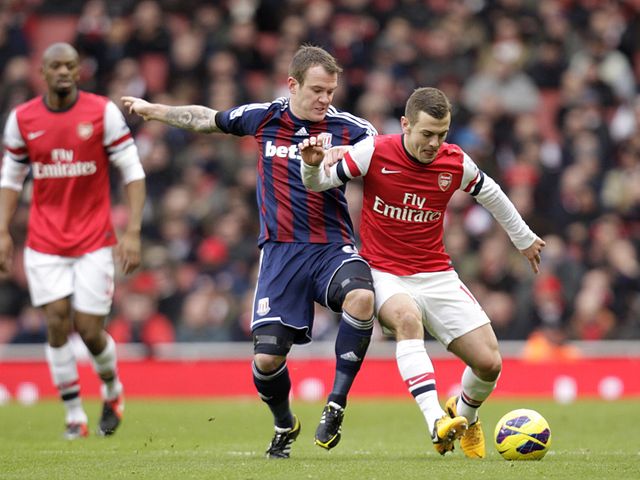 Whelan puts Wilshere under pressure.