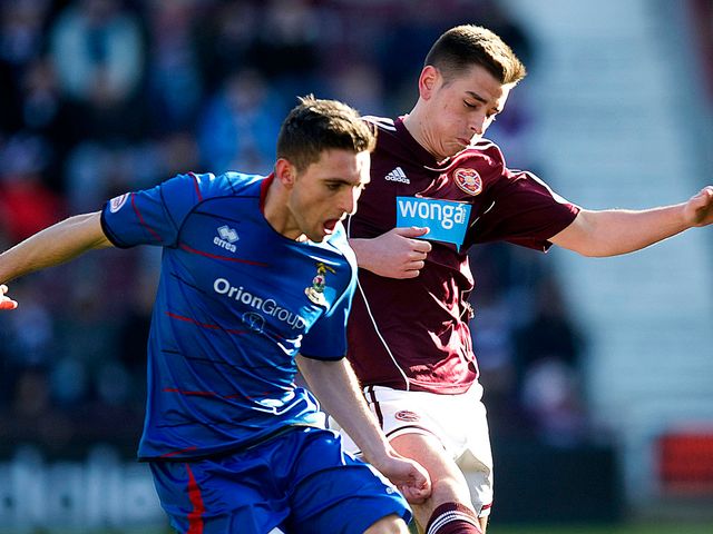 Graeme Shinnie turns away from Hearts' Jamie Walker