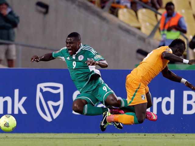 Emenike and Tiote take a tumble.