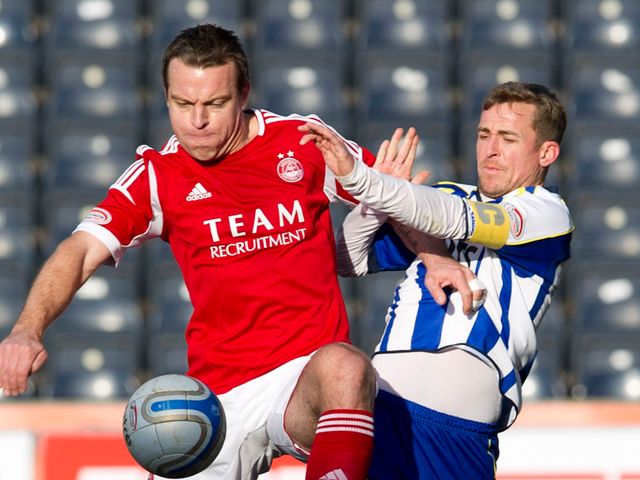 Gavin Rae and James Fowler battle for the ball
