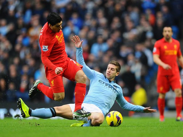 Suarez looks to escape from Nastasic.
